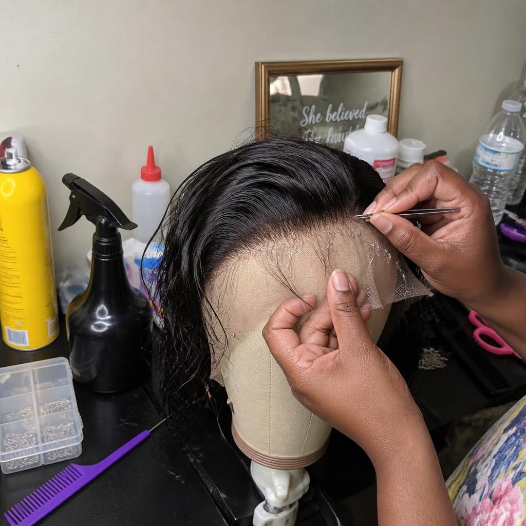 Wig unit on a mannequin head being plucked and customized